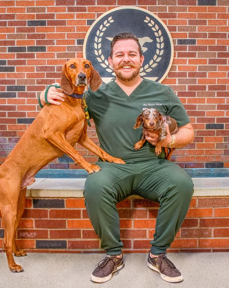 Dr. Glen Hudson, (DVM) Veterinarian, with a dog